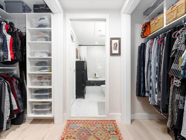 Spacious closet with wood finished floors and attic access | Image 17