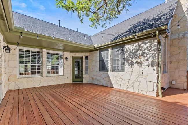 This deck offers endless possibilities, overlooking the lush, shaded green space below for a perfect outdoor escape. | Image 30