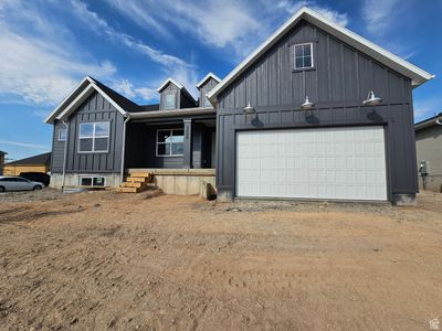 View of front of home with a garage and a porch | Image 2