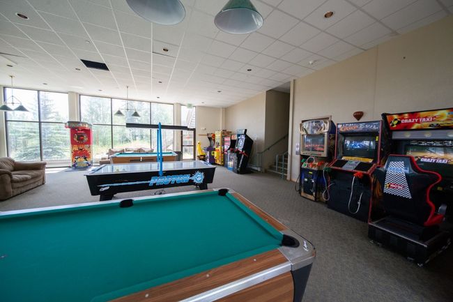 Rec room with carpet, billiards table, and a paneled ceiling | Image 22