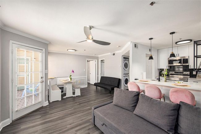 View from living area towards dining, bathroom, and bedroom | Image 8