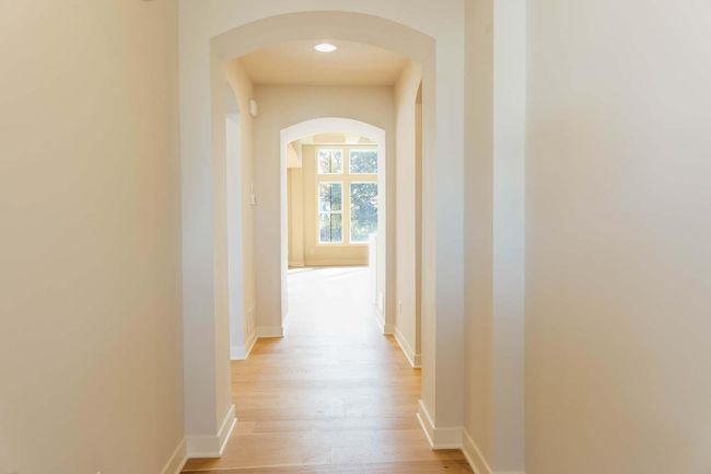 Thoughtful entry & Details throughout, including Arches, 12'H Gathering Room Ceiling Height and Wall of windows! Photos may not depict actual home plan configuration. Features/materials/finishes shown contain options that are not included in price. | Image 8