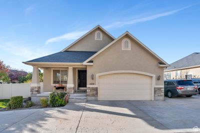 View of front of house with a porch and a garage | Image 1