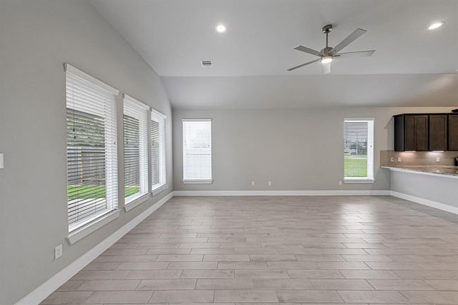 Spacious family room filled with natural light. | Image 16