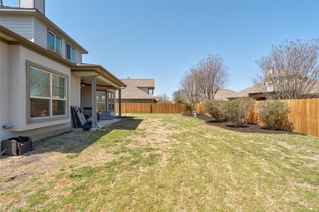 View of yard with a fenced backyard, a patio area, and a ceiling fan | Image 31