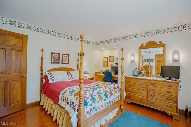 Bedroom with wood finished floors and recessed lighting | Image 23