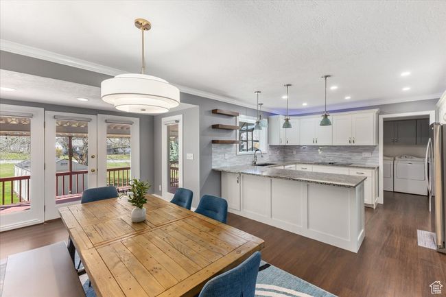 Dining room featuring recessed lighting, washer and dryer, dark wood-style flooring, and crown molding | Image 7