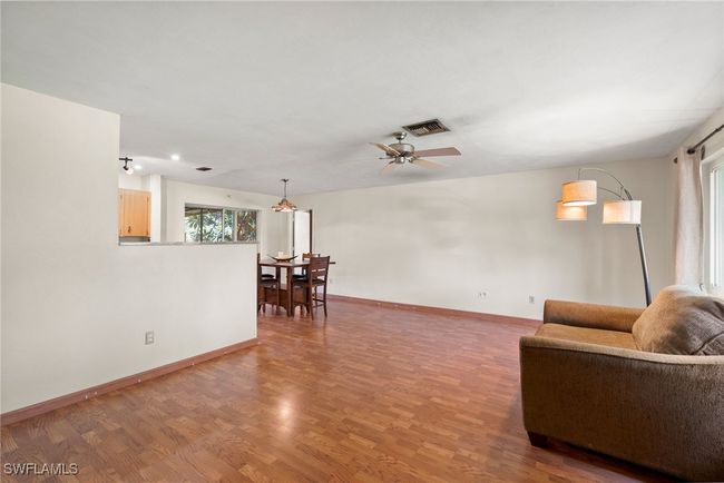 Living room featuring hardwood / wood-style flooring and ceiling fan | Image 4