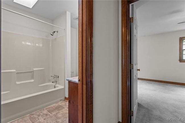 Bathroom featuring shower / bath combination, vanity, and a skylight | Image 23