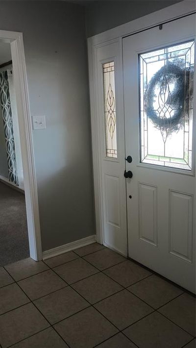 Carpeted living room with ceiling fan and lofted ceiling | Image 3