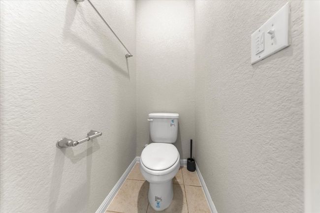 Bathroom with tile patterned floors, toilet, and baseboards | Image 23