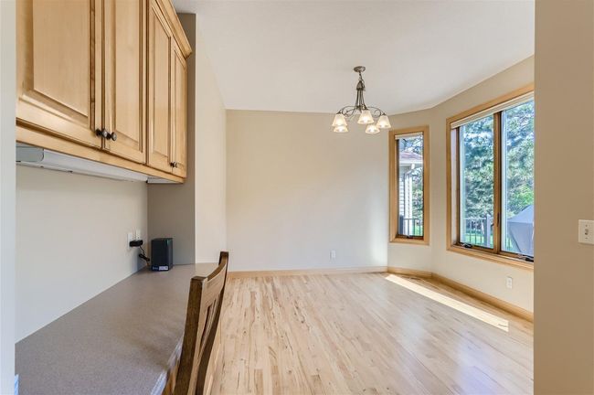 The breakfast room which overlooks the beautiful backyard and tree line. Even a convenient desk area, too! | Image 6