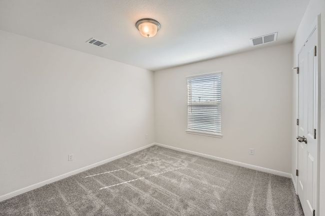 Carpeted empty room featuring visible vents and baseboards | Image 21