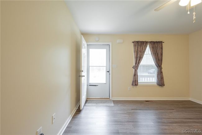 Spare room with baseboards, ceiling fan, and wood finished floors | Image 4