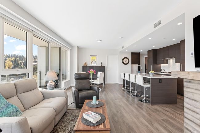 Living room featuring recessed lighting, light wood-style floors, and visible vents | Image 12