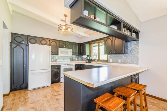 Kitchen has tons of cabinet space and beautiful flooring! | Image 19