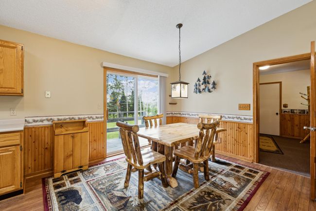 Walk into the dining room from the breezeway between the home and garage. | Image 14