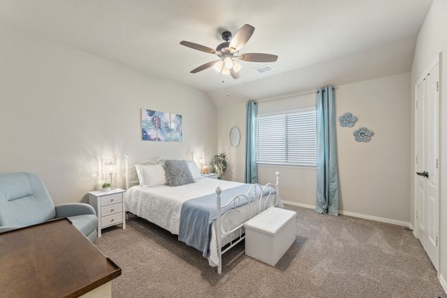 Carpeted bedroom with vaulted ceiling, a ceiling fan, and a closet | Image 36
