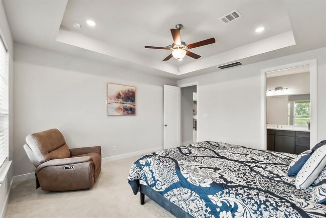 Nice tray ceiling detail and recessed can lights in the primary. | Image 15