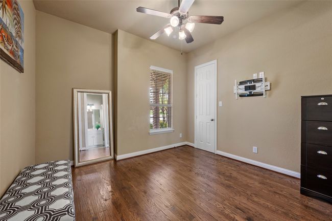 Unfurnished bedroom with wood finished floors and a ceiling fan | Image 25