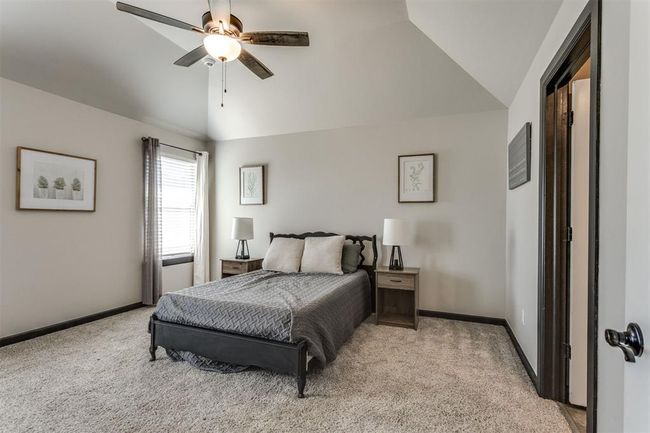 Bedroom featuring lofted ceiling, baseboards, and light carpet | Image 26