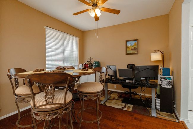 Dining space with baseboards, ceiling fan, and wood finished floors | Image 6