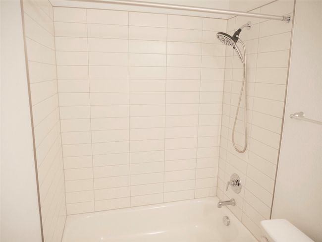Clean bath with white quartz countertops | Image 23