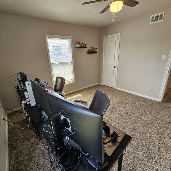 Office space with ceiling fan, carpet flooring, and baseboards | Image 25
