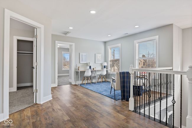 Loft with recessed lighting, wood finished floors, an upstairs landing, baseboards, and attic access | Image 30