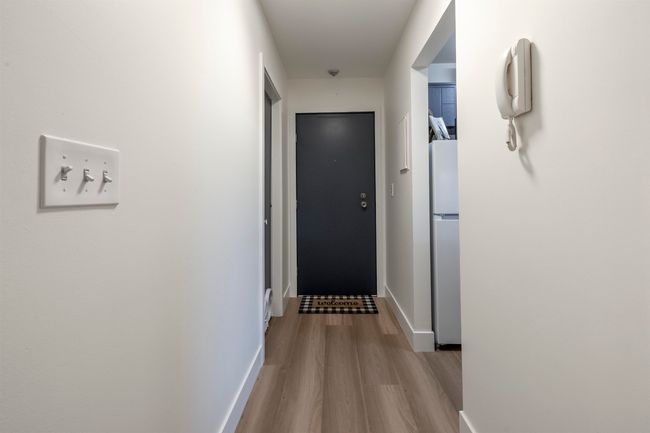 Corridor with baseboards and wood finished floors | Image 21