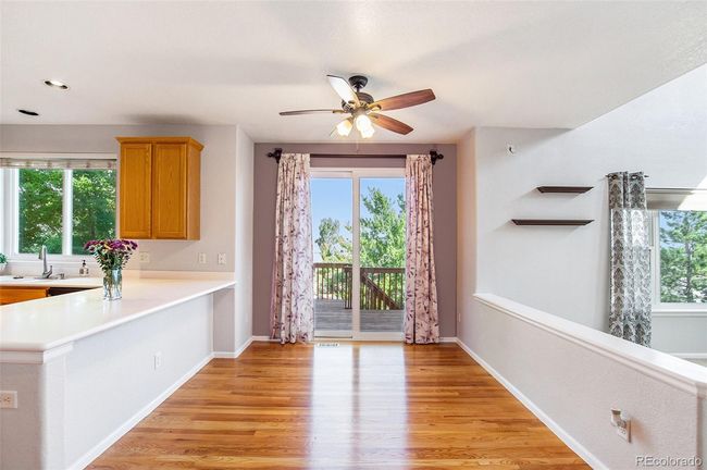 Dining area between kitchen and living room with door to outside deck with views | Image 7