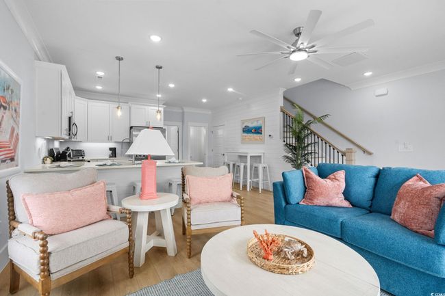 Living room featuring ornamental molding, light wood finished floors, recessed lighting, stairs, and ceiling fan | Image 12