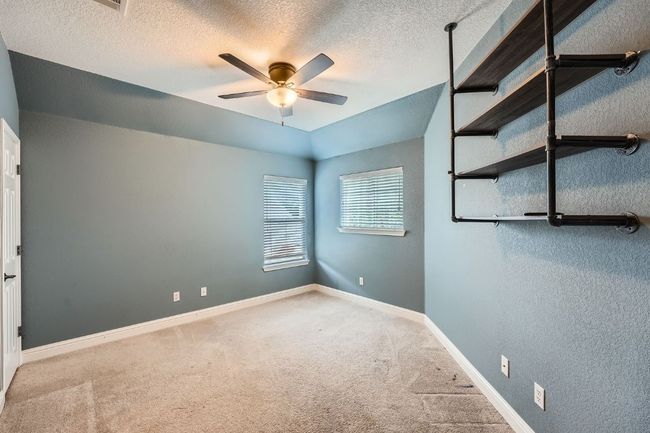 Unfurnished bedroom featuring carpet floors, baseboards, a textured wall, and a textured ceiling | Image 24