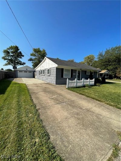 Ranch-style home with a garage and a front yard | Image 2