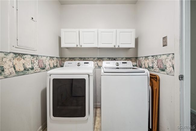 Washroom featuring washing machine and dryer and cabinet space | Image 13
