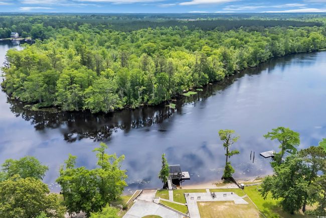 Bird's eye view of a heavily wooded area and a nearby body of water | Image 33
