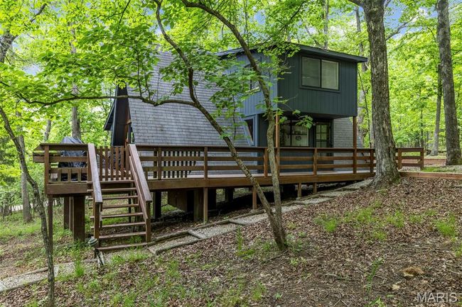 Rear view of house featuring a deck and stairway | Image 49