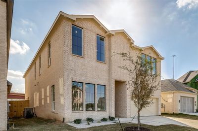 View of front of home with a garage and central AC | Image 3