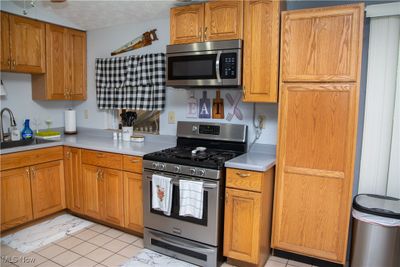 Kitchen featuring sink, stainless steel appliances, and a textured ceiling | Image 2