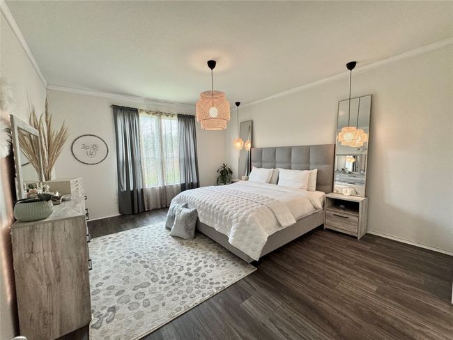 Bedroom with dark wood-type flooring and ornamental molding | Image 17