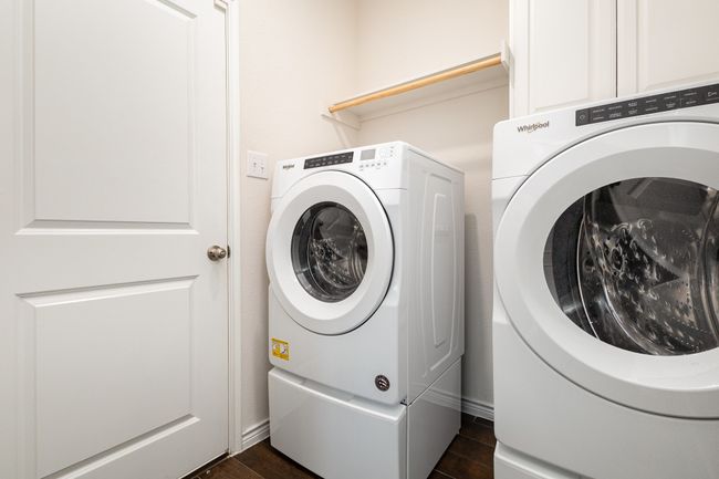 Washroom featuring baseboards, washer and dryer, and dark wood-style floors | Image 26