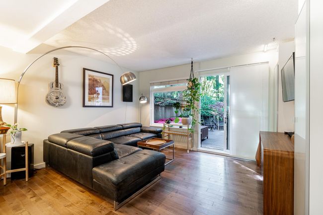 Living room featuring hardwood / wood-style flooring and a textured ceiling | Image 9
