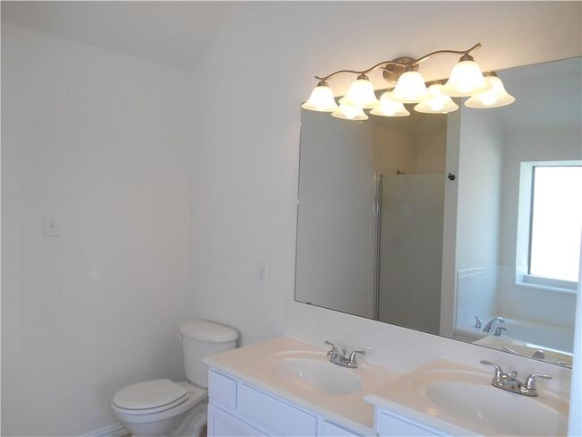 Master Bath featuring double vanity, a shower, and a bath tub | Image 17