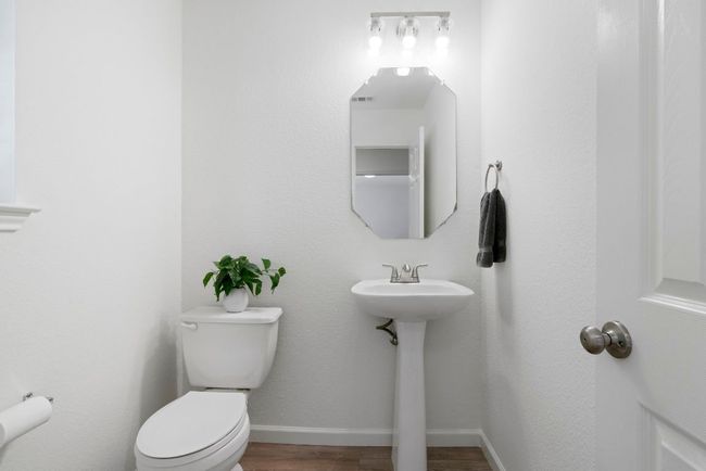 The main level features guest powder room. | Image 17