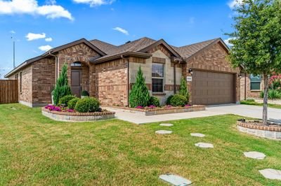 View of front with a garage and the front lawn | Image 1