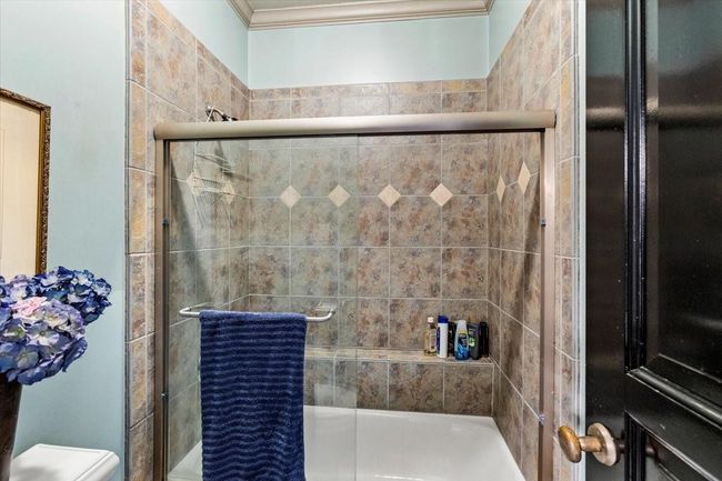 This second upstairs bathroom has a shower/bathtub combo and two sinks. | Image 40