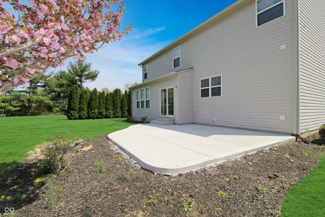 Appreciate the low maintenance and generous size of this concrete patio, ideal for creating your perfect outdoor retreat. | Image 21