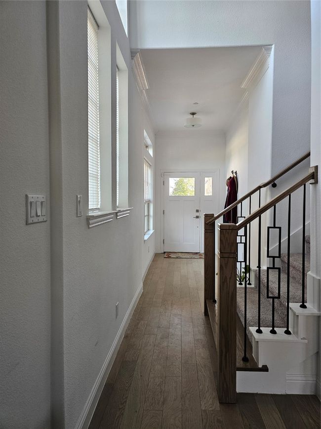 Hall featuring ornamental molding, stairs, and wood-type flooring | Image 16