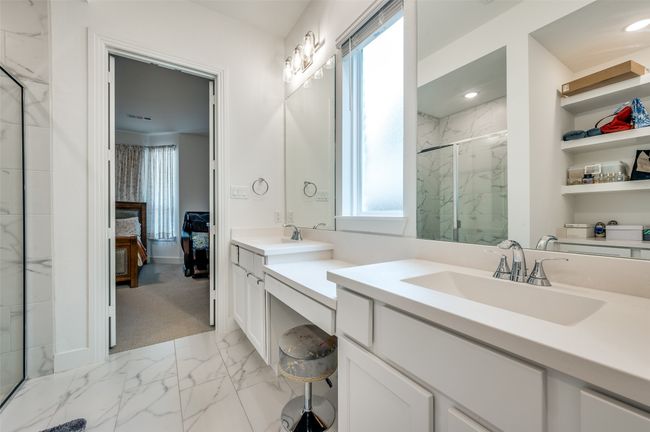 Bathroom featuring marble look tiles, ensuite bath, a marble finish shower, and vanity | Image 15