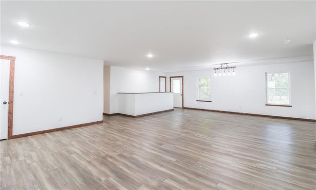 Empty room with light wood-type flooring | Image 4